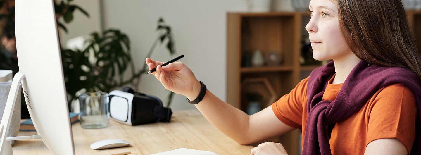 Middle school-aged student works at a computer