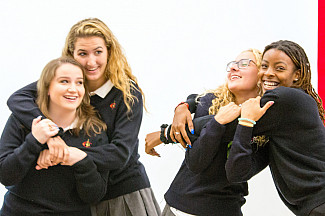 Four students embrace during the Sisterhood Mass on August 29, 2019.